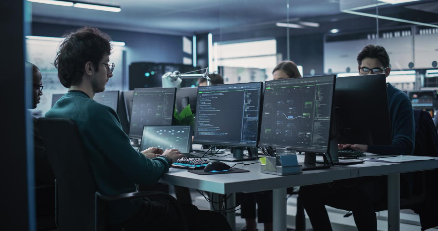 An image of people working on computers in a office.